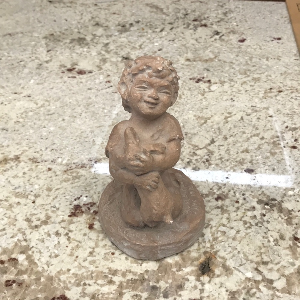 Little Boy Holding Dog Figurine